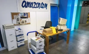 Jeff Bezos working at a desk inside the garage in Bellevue, Washington, where Amazon was started in 1994